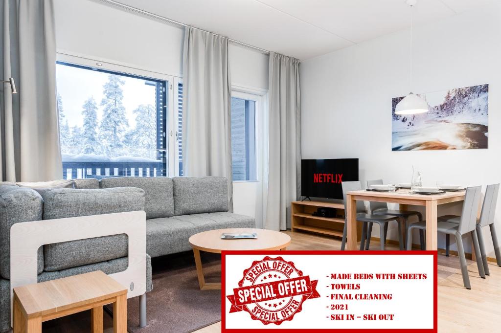 a living room with a couch and a table at RukaHillChalet4 Ski In - Ski Out in Ruka