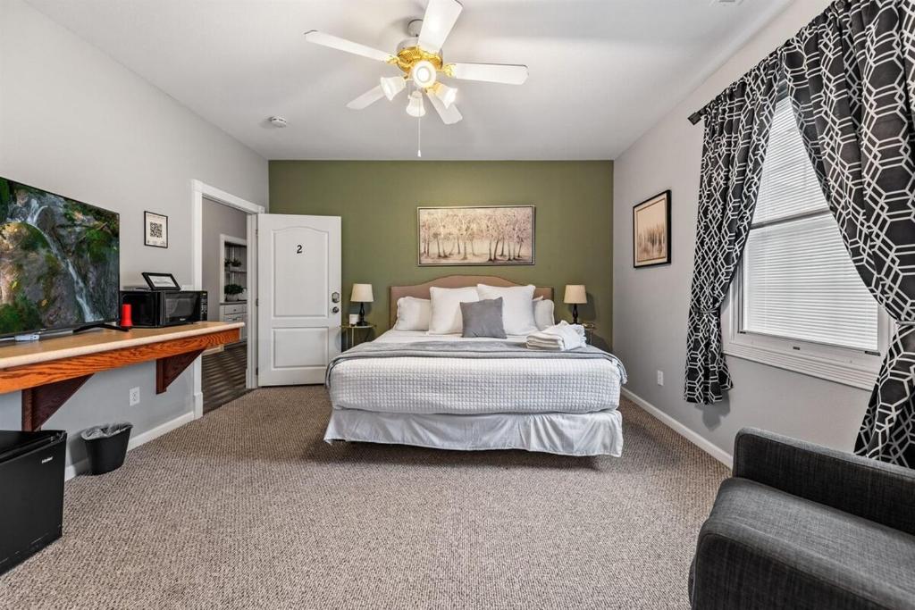 a bedroom with a bed and a ceiling fan at NEW King Bed,Suite,Downtown BR Southern Charm Boxcar in Blue Ridge