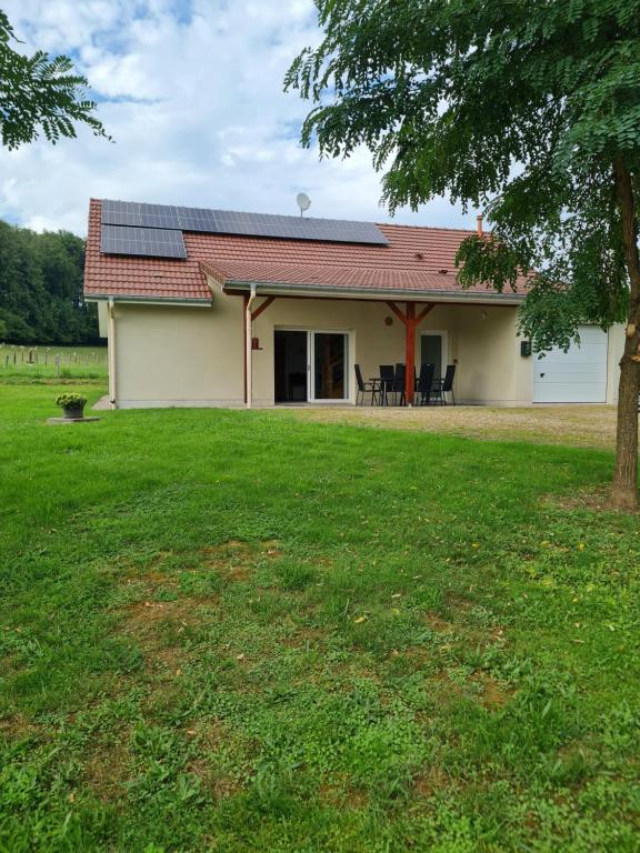 a house with solar panels on the roof at La Maison de choupette in Fougerolles