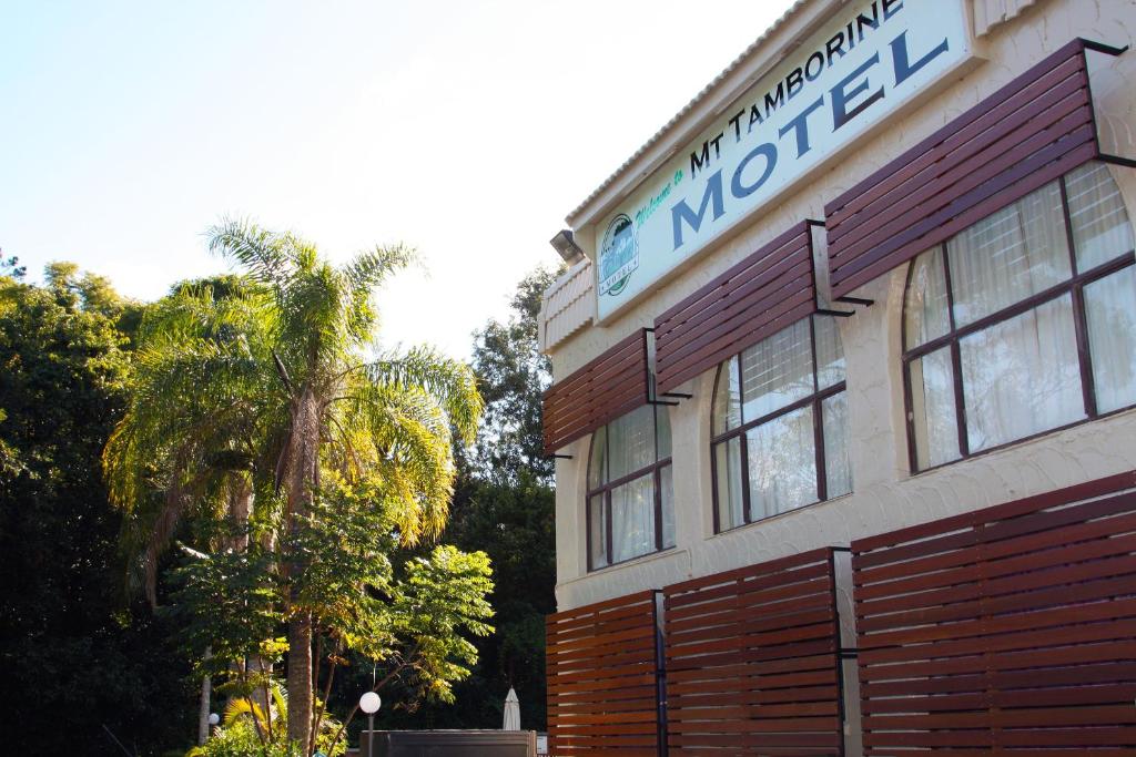a large building with a sign on the front of it at Mt Tamborine Motel in Mount Tamborine