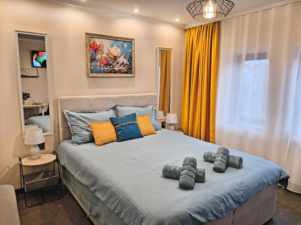 a bedroom with a bed with two pillows on it at St Sava Legendary House in Veliko Tŭrnovo