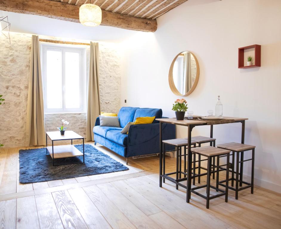 a living room with a blue couch and a table at Antibes Old Town Haven in Antibes