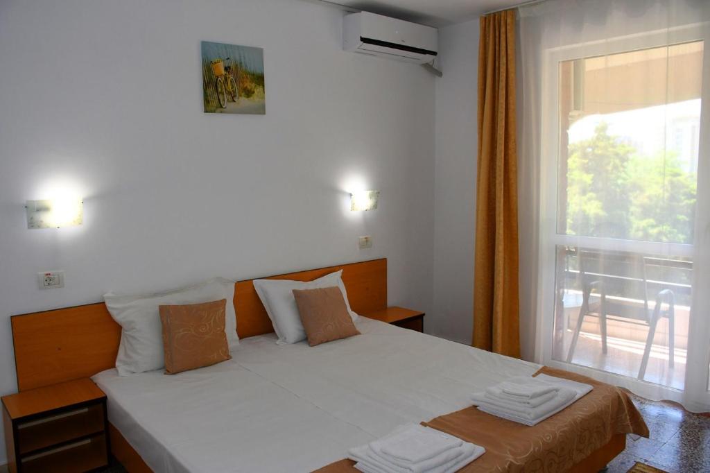 Postel nebo postele na pokoji v ubytování Hotel Sanda