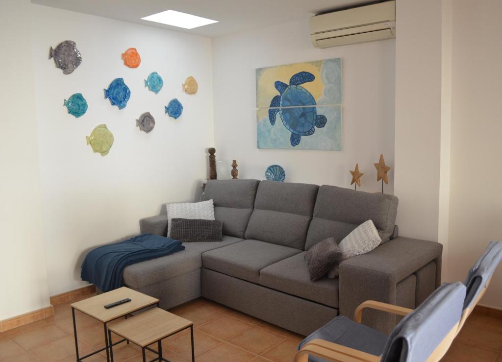 a living room with a couch and a table at Arbocer playa Puçol in Playa de Mar