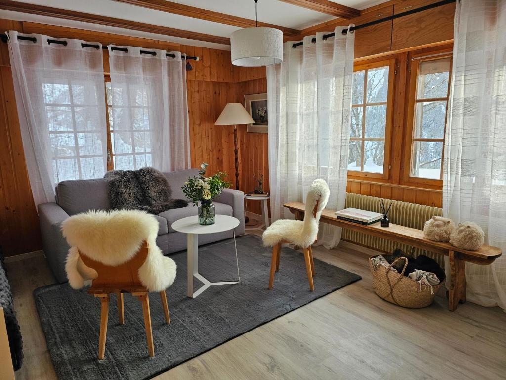 a living room with a couch and two chairs at Chalet Alpin vue Dent Blanche in La Forclaz