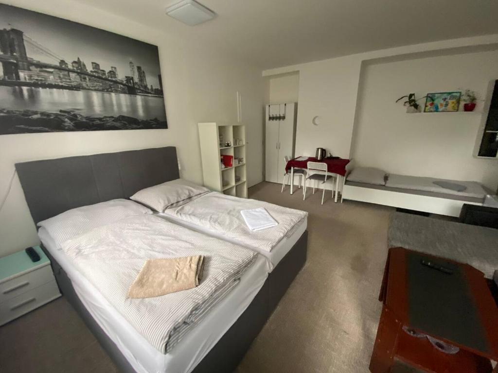 a bedroom with a bed and a table in it at Homestay U Hanky in Zdiby