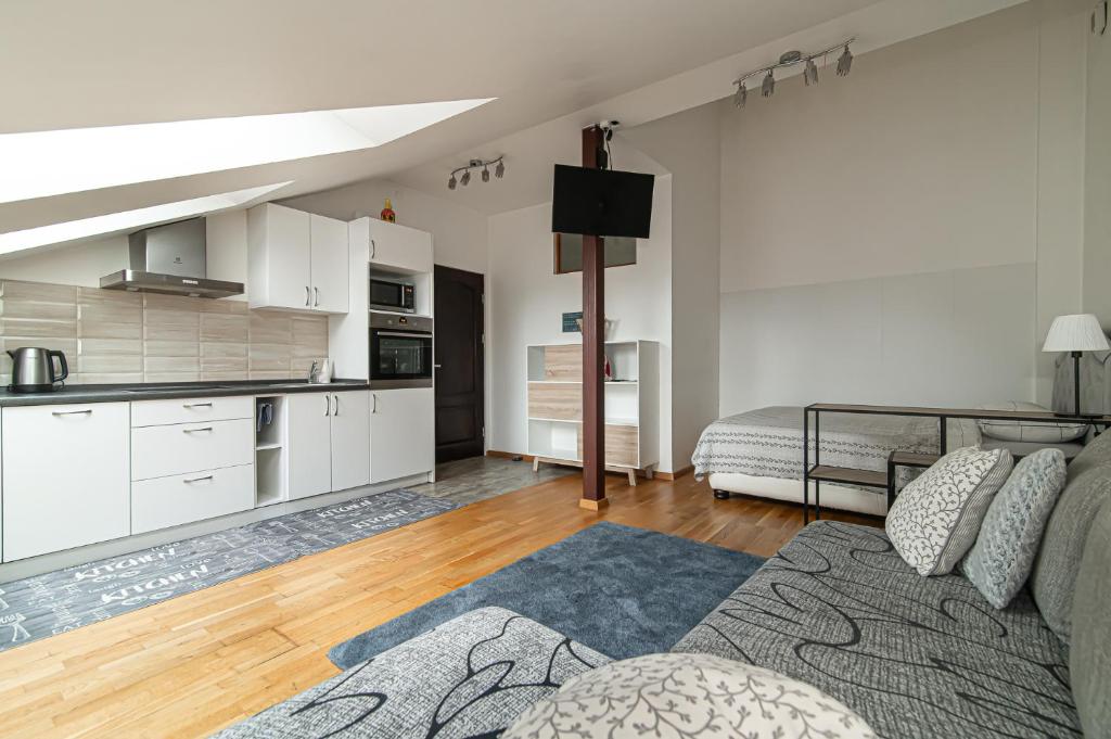 a large living room with a couch and a kitchen at Vilnius Old Town Happiness in Vilnius