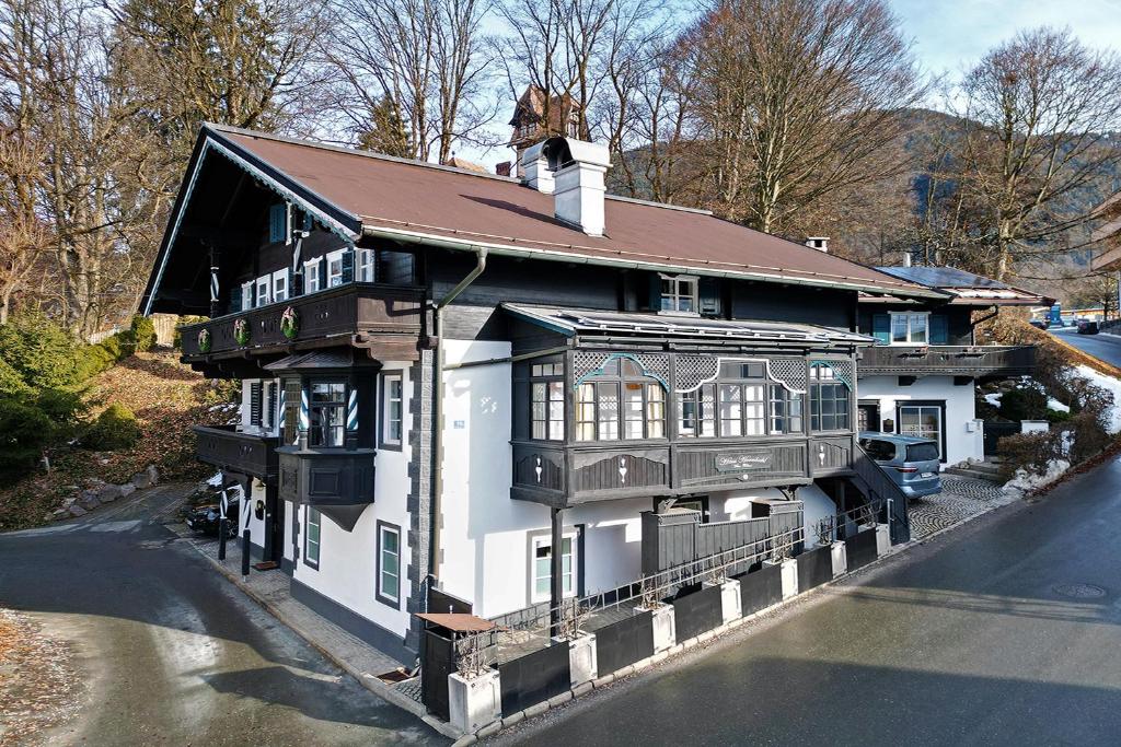 a large white house with a brown roof at NA-Home Kitzbühel Hornbichl in Kitzbühel