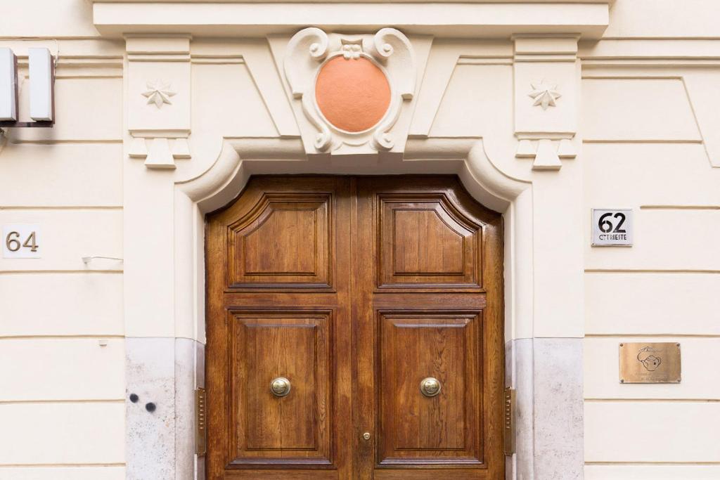 a wooden door on a white building at A Casa Di Giorgia in Rome