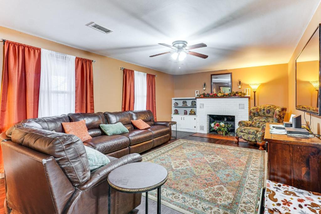 a living room with a leather couch and a fireplace at Less Than 1 Mi to Main St Berryville Spacious Family Home in Berryville