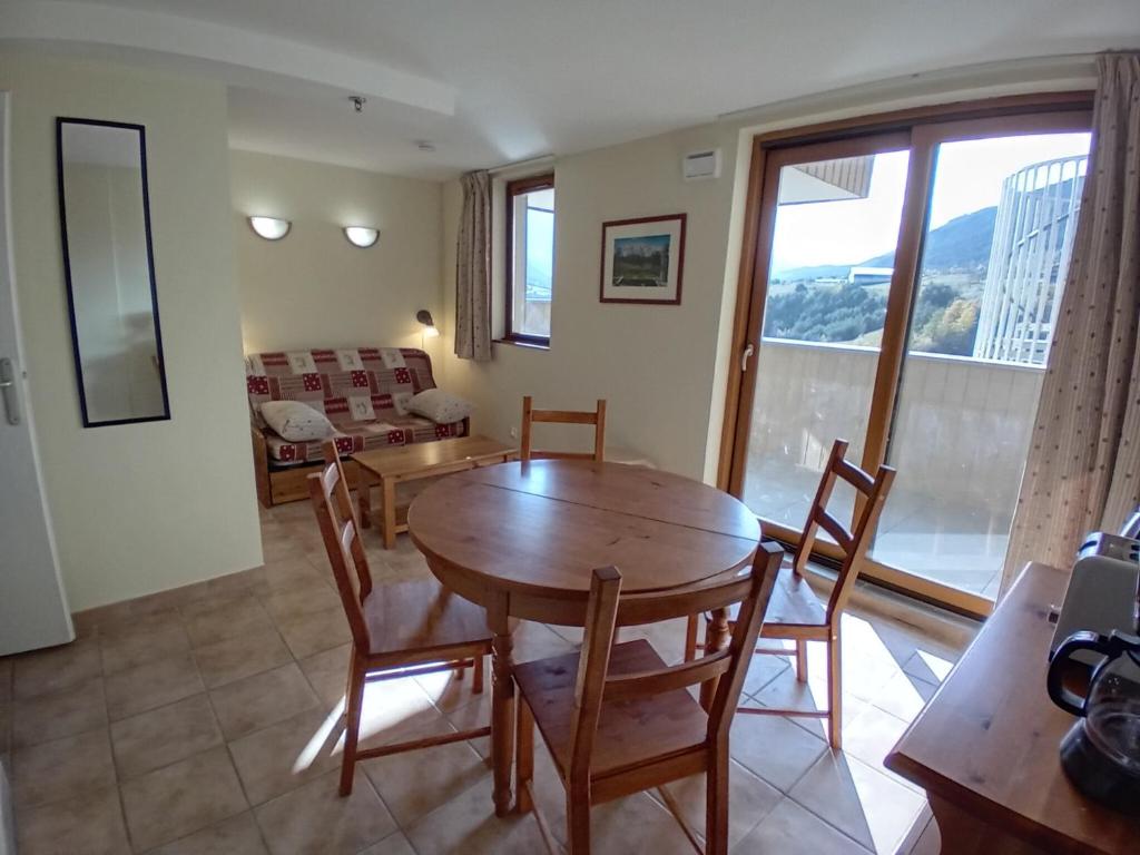 a living room with a wooden table and chairs at Apartment for 4 people in Val Cenis in Val Cenis