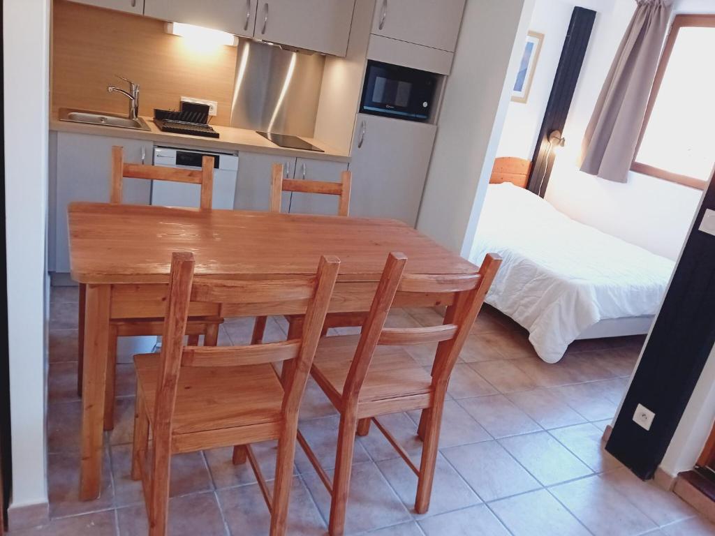 a kitchen with a wooden table and chairs in a room at Apartment Termignon ski-in ski-out location in Val Cenis
