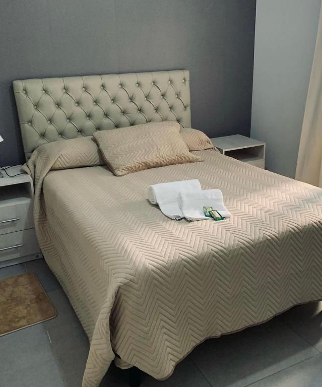 a large bed with two towels on top of it at Valentino Apart 1 in Villa María