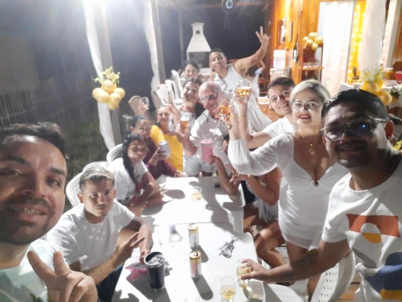a group of people posing for a picture at a table at La Casa Magno's Ajuruteua in Bragança