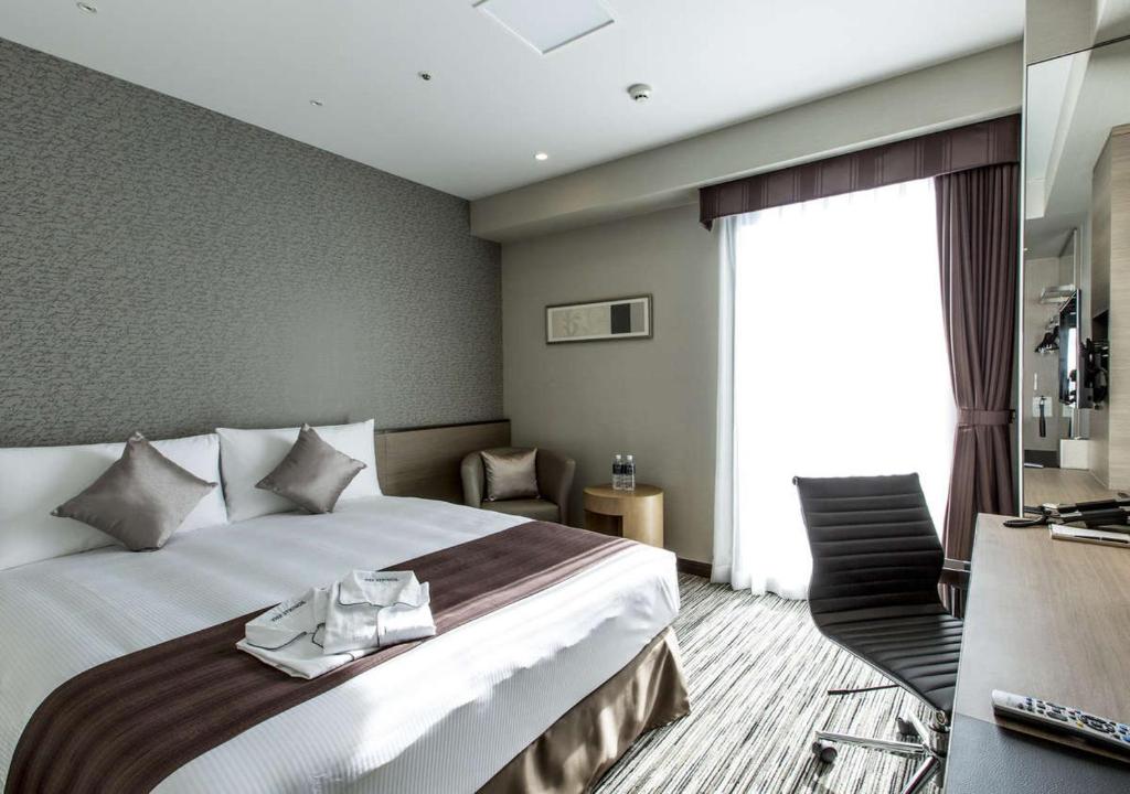 Postel nebo postele na pokoji v ubytování The Strings Hotel Nagoya