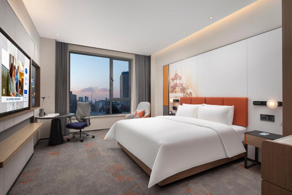 Postel nebo postele na pokoji v ubytování Hampton by Hilton Baoding High-tech Zone