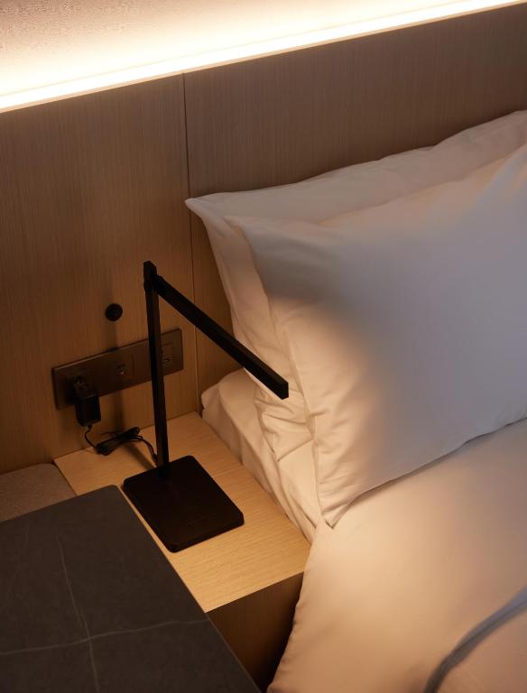 Postel nebo postele na pokoji v ubytování Homes Stay Myeongdong