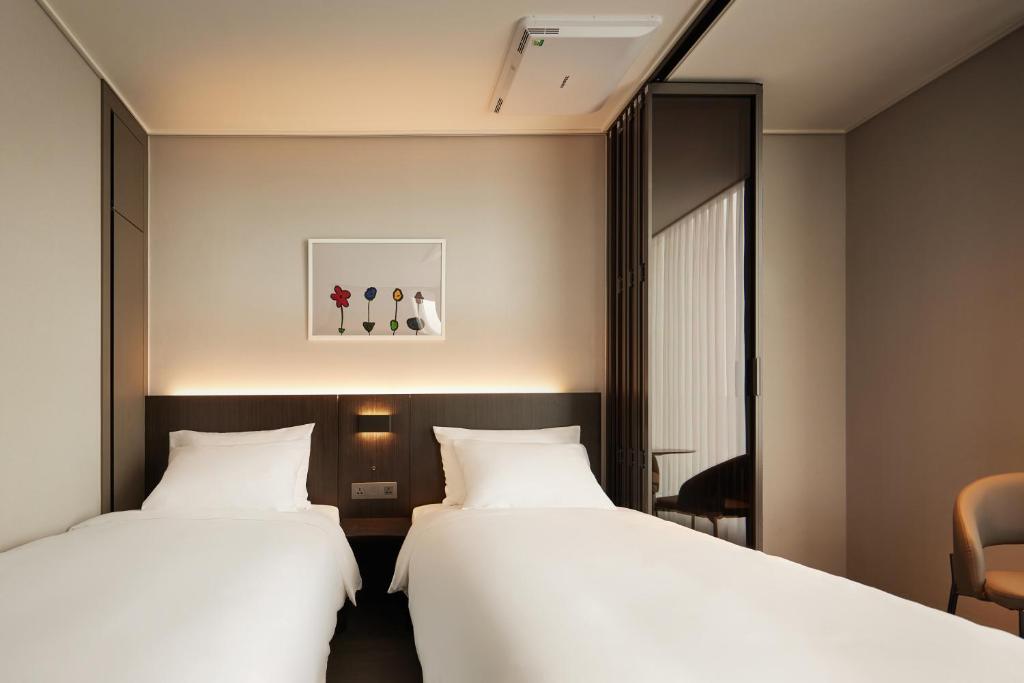 Postel nebo postele na pokoji v ubytování Homes Stay Myeongdong
