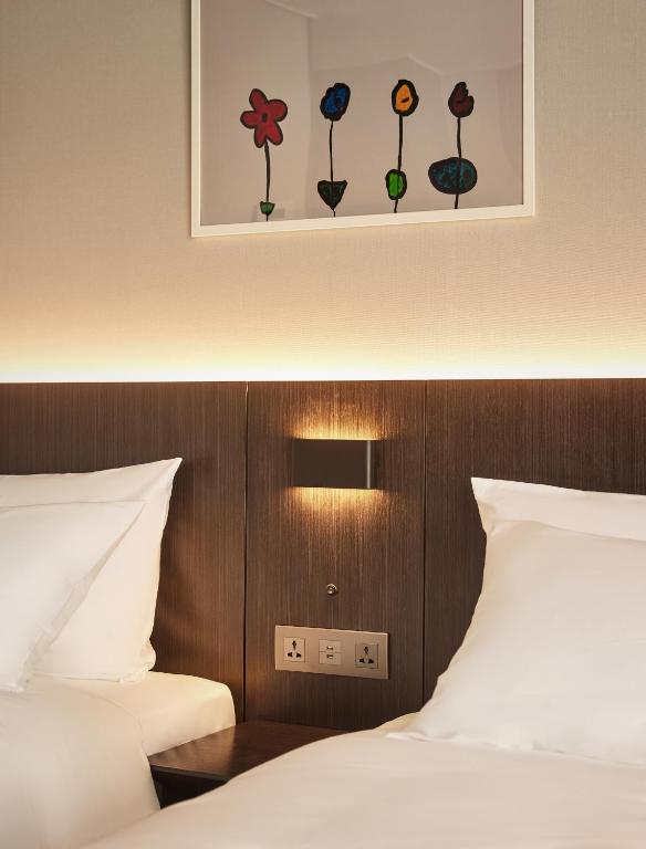 Postel nebo postele na pokoji v ubytování Homes Stay Myeongdong
