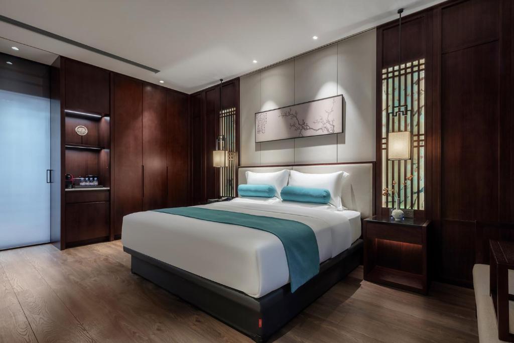 Postel nebo postele na pokoji v ubytování Xinghuacun Hotel