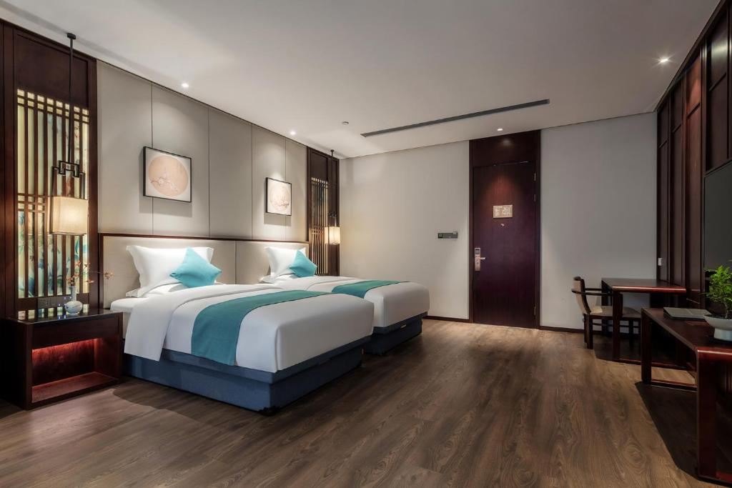 Postel nebo postele na pokoji v ubytování Xinghuacun Hotel