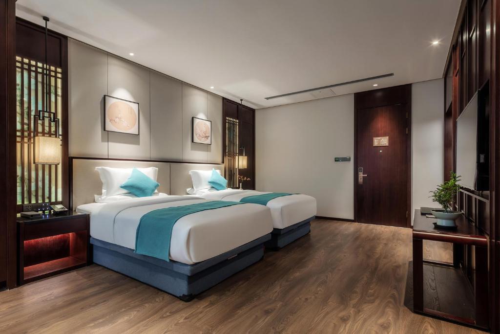 Postel nebo postele na pokoji v ubytování Xinghuacun Hotel