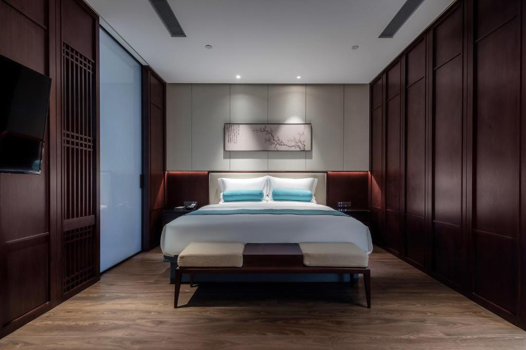 Postel nebo postele na pokoji v ubytování Xinghuacun Hotel
