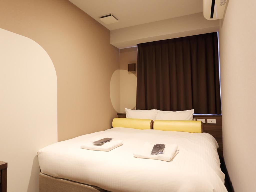 Postel nebo postele na pokoji v ubytování RE Hotel 谷町9丁目2