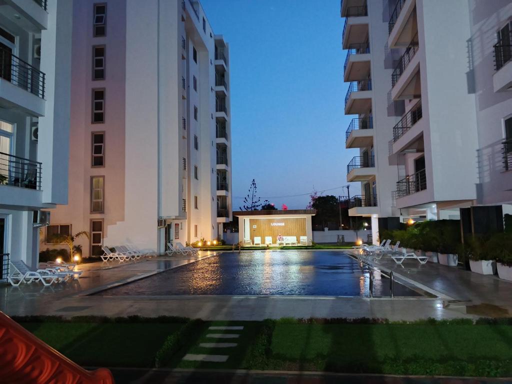 an empty courtyard between two buildings at night at Fully furnished apartment in Nyali near the beach in Mombasa