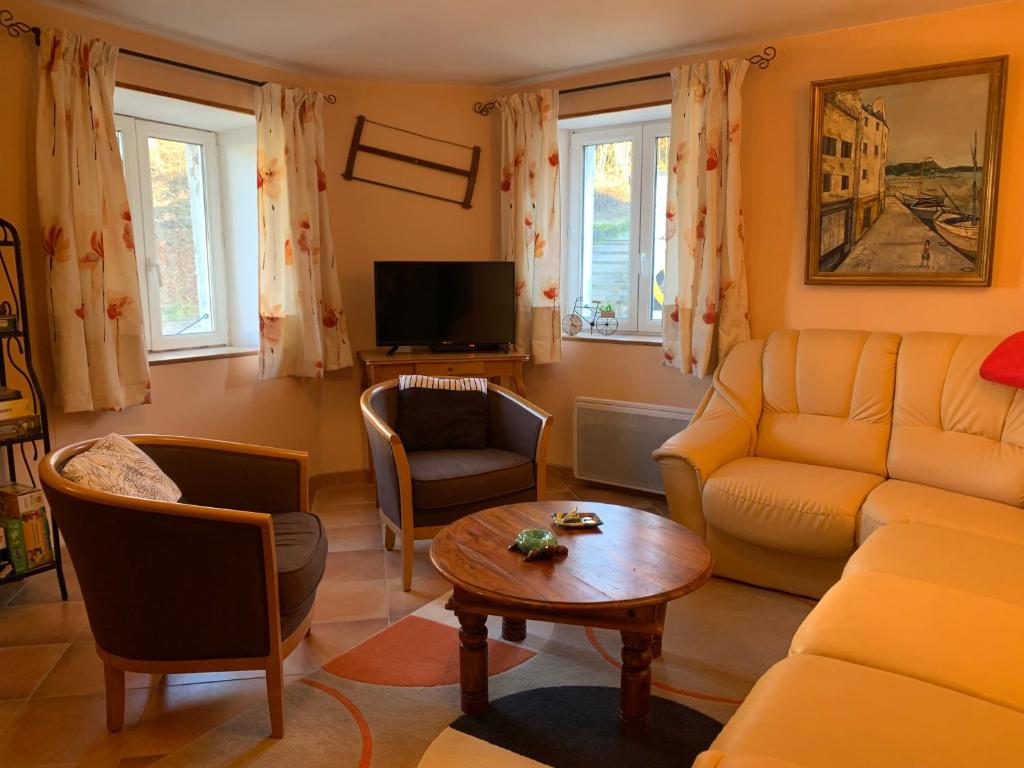 a living room with a couch and a table at MAISON Cornimont in Cornimont