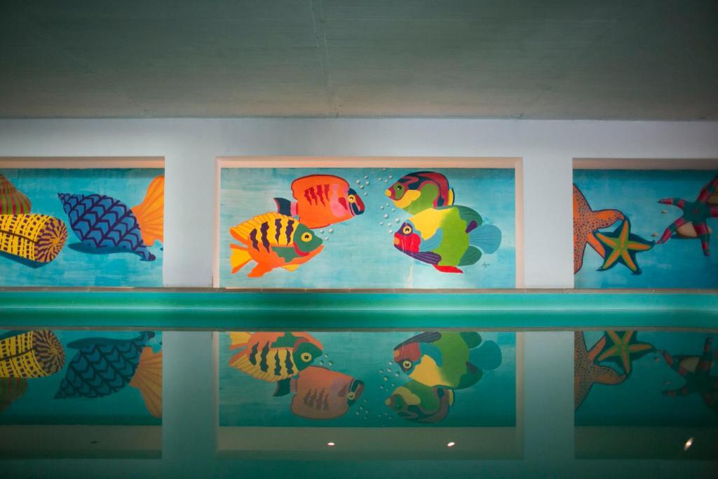 a wall with three pictures of fish on it at Mirachoro Carvoeiro in Carvoeiro