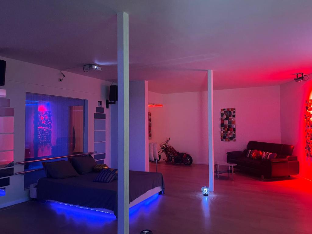 a living room with red and blue lights at Le Luxe in Fléron