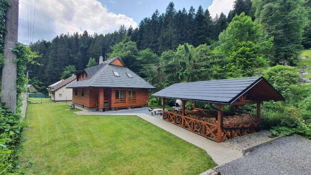 a log cabin with a gazebo in a yard at Chata Romeo in Harmanec
