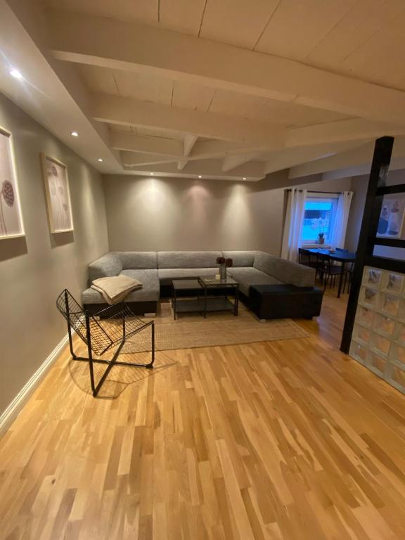 a living room with a couch and a table at Dronningens Gate 95, 0402 Kristiansand in Kristiansand