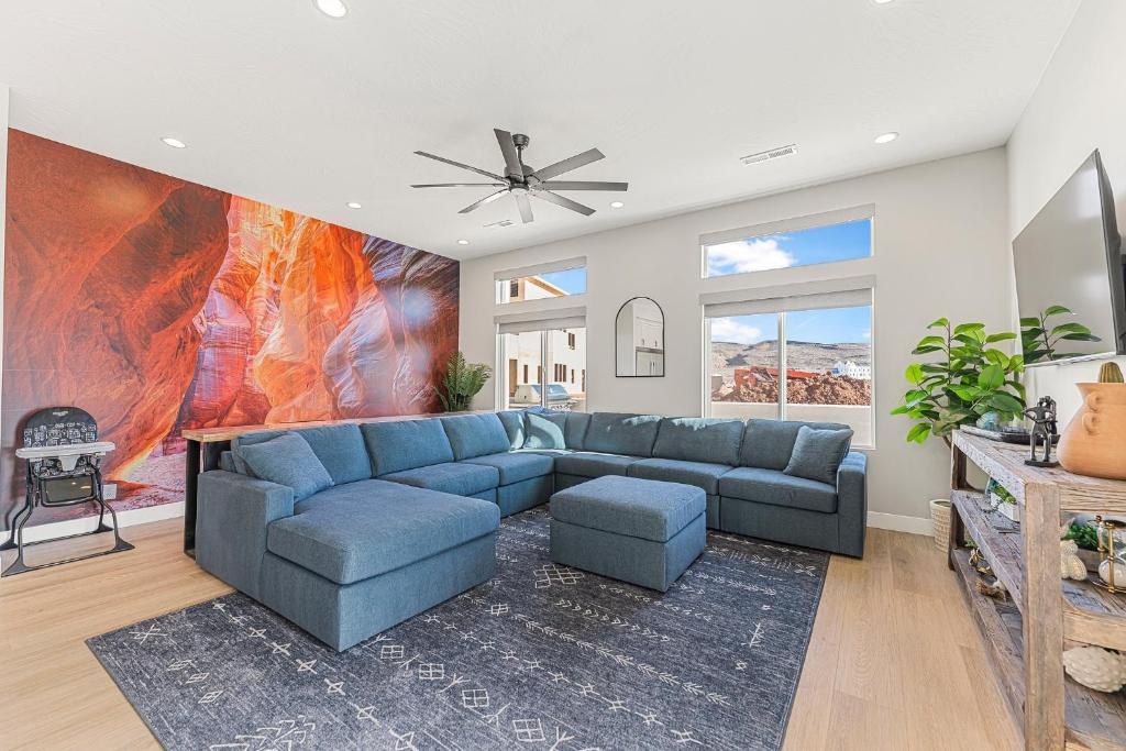 a living room with a blue couch and a fireplace at Slickrock Shore townhouse in St. George
