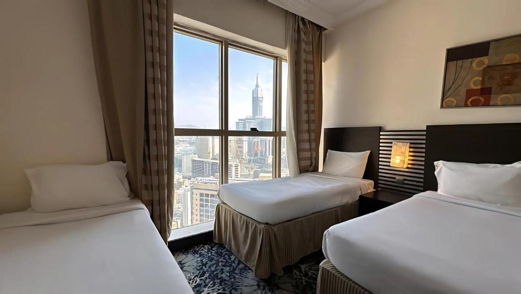 Postel nebo postele na pokoji v ubytování Al Kiswah Tower 5 Hotel