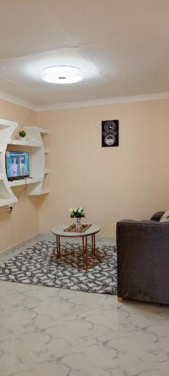 a living room with a table and a couch at EsMash Homes Air,bnb Lanet Nakuru in Nakuru