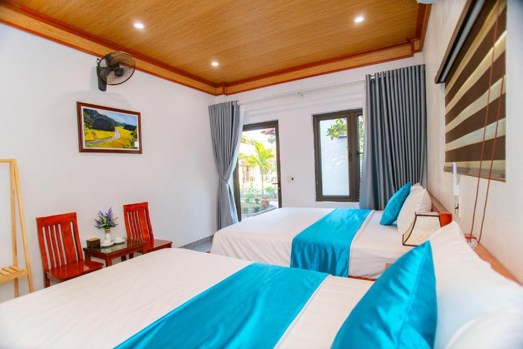 a bedroom with two beds and a window at Tam Coc Minh Quan Homestay in Ninh Binh