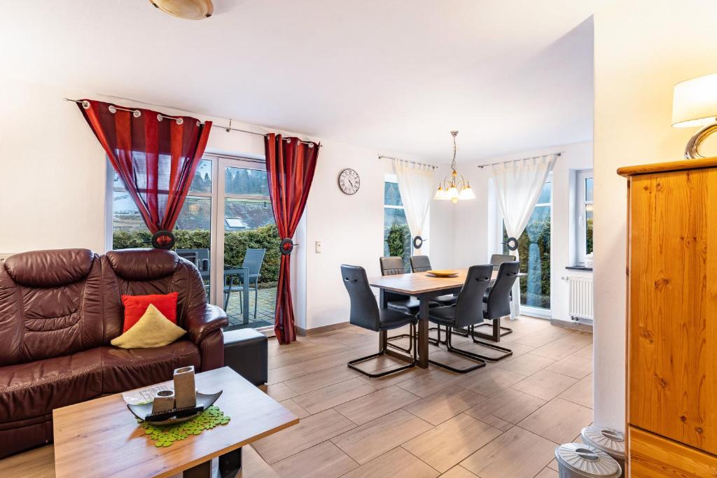 a living room with a couch and a table at Fewo Zur Piste in Willingen