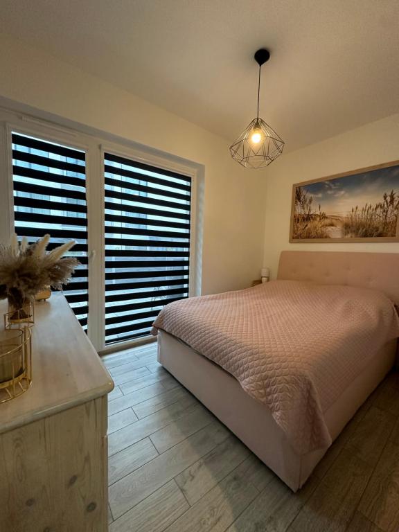 Postel nebo postele na pokoji v ubytování Słoneczne Apartamenty VIKI