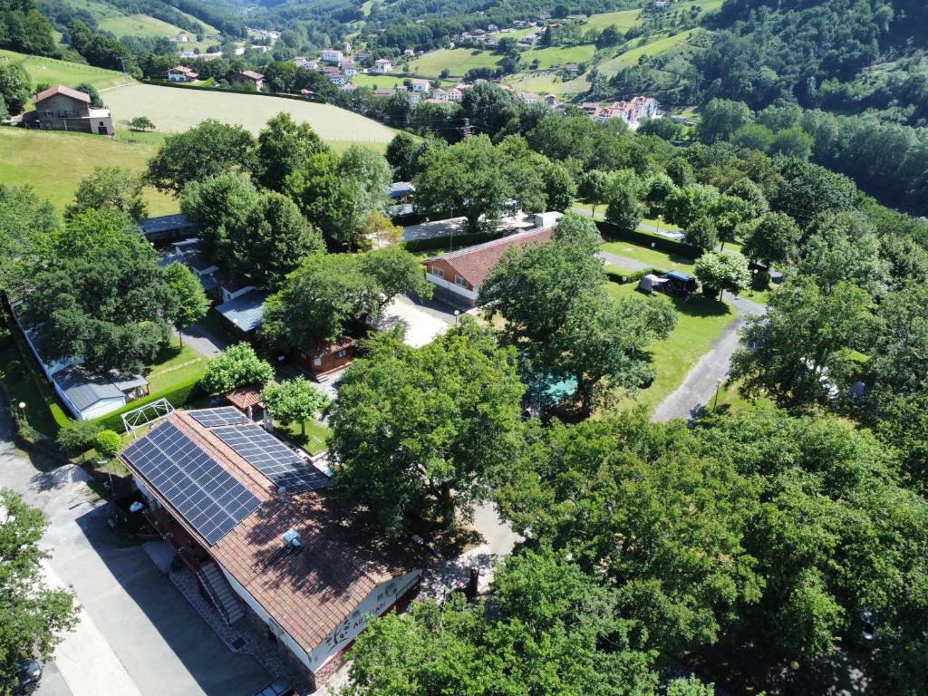an overhead view of a house with a solar roof at Camping Ariztigain in Sumbilla