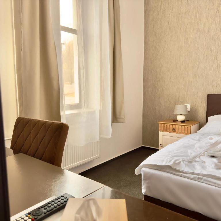 Postel nebo postele na pokoji v ubytování Hotel Zelený dům