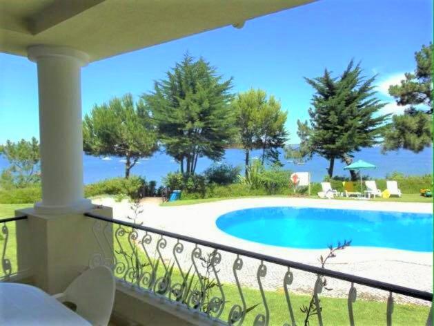 a balcony with a view of a swimming pool at Troia Apartments in Troia