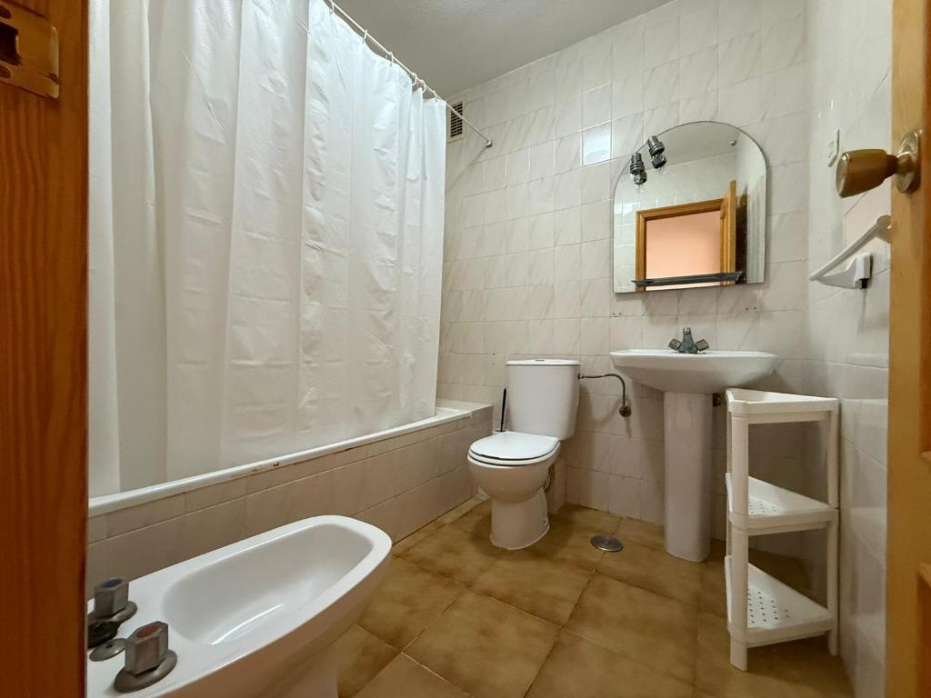 a bathroom with a toilet and a sink and a bath tub at Marco Polo by Alina365 in La Manga del Mar Menor