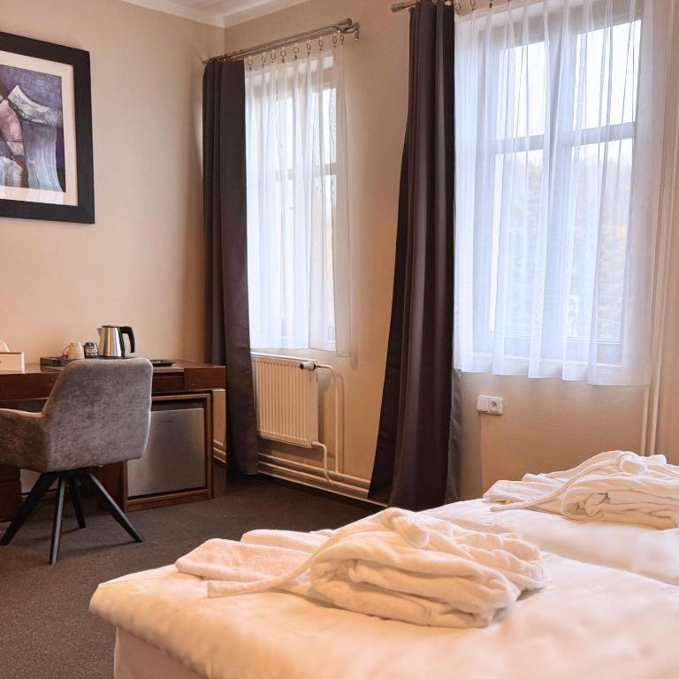 Postel nebo postele na pokoji v ubytování Hotel Zelený dům