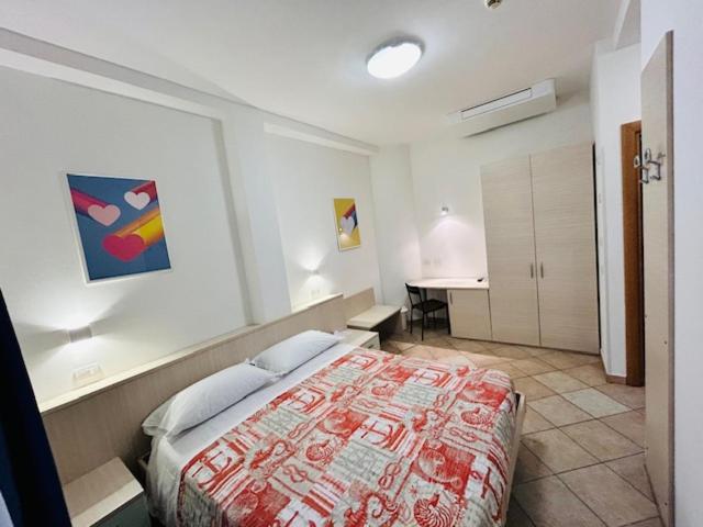 a bedroom with a large bed in a room at Hotel Aurora in San Vincenzo