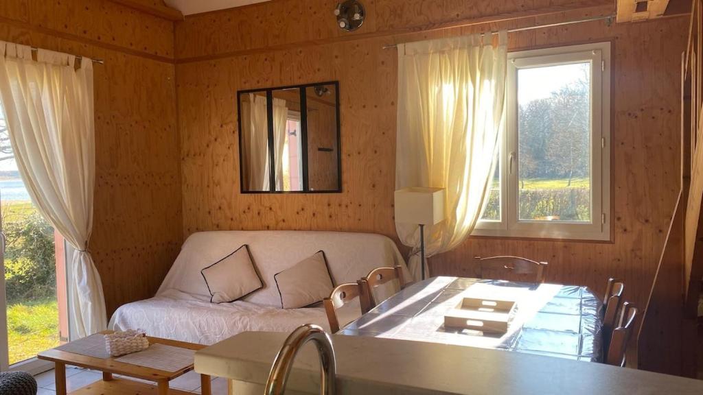 un salon avec un canapé et une table dans l'établissement Cottage 19 Bulle Der jusque 8 Personnes vue Lac du Der, à Giffaumont