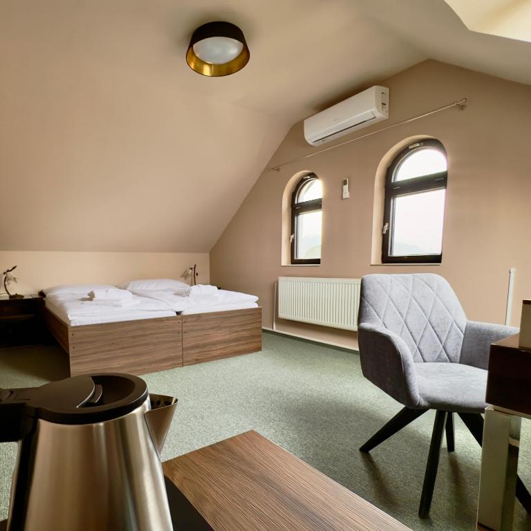 Postel nebo postele na pokoji v ubytování Hotel Zelený dům