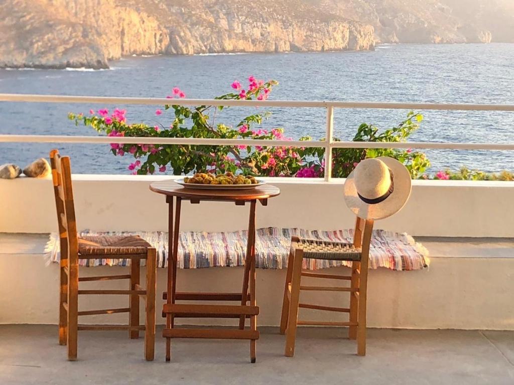 a table and two chairs on a balcony overlooking the ocean at Sea View 180' in Kalymnos