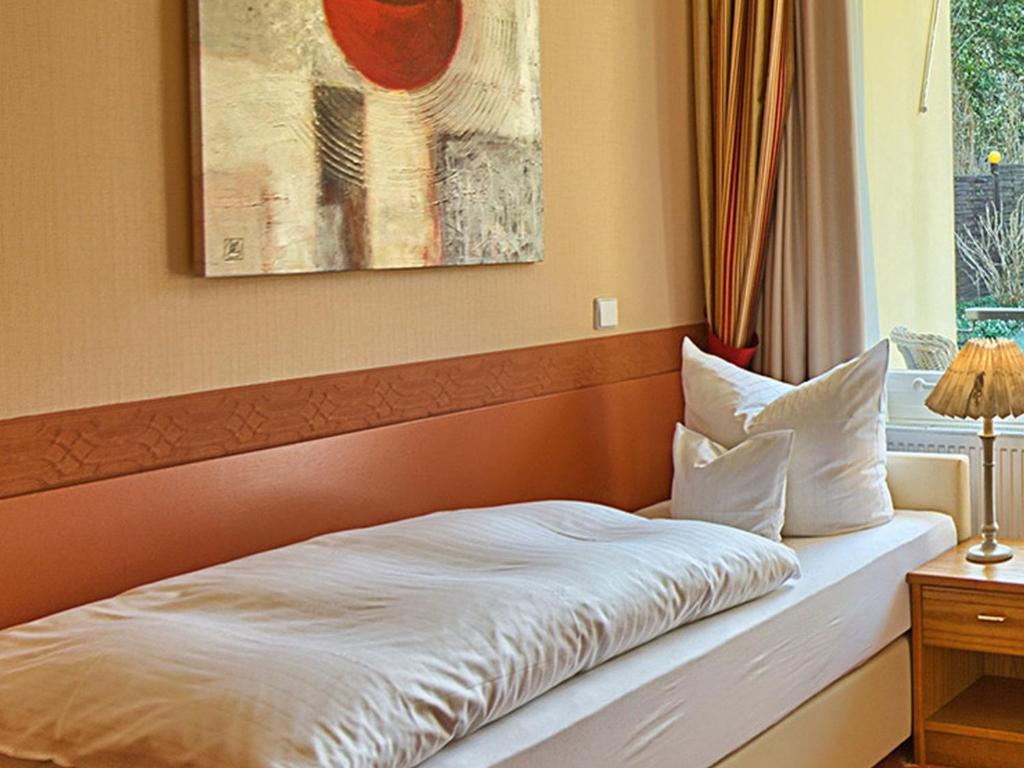 Postel nebo postele na pokoji v ubytování Hotel Burgblick